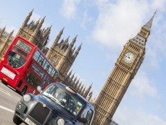 LONDON, UNITED KINGDOM - OCTOBER 27, 2013: Famous Black Cab on Westminster Bridge with Big Ben and Palace of Westminster on background